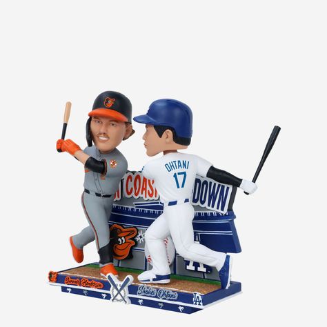 Charm City meets Tinseltown! Take it out to the wild west for a battle to remember with the Gunnar Henderson & Shohei Ohtani Baltimore Orioles & Los Angeles Dodgers West Coast Sho Down Dual Bobblehead. Features Portrays Henderson wearing his grey uniform and Ohtani wearing his white gameday uniform in action poses, ready to make the plays of the game Thematic, team colored backdrop and base with stadium and baseball accents that will look great in your collection Team logo displays on backdrop, Los Angeles, Baltimore Orioles, Angeles, Grey Uniform, Gunnar Henderson, Baseball Bat Display, Bat Display, Charm City, Shohei Ohtani