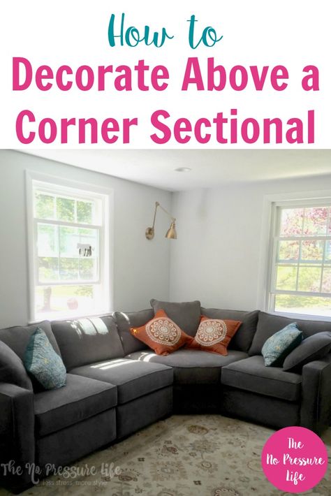 Decorating around corner sectionals can be tricky, so these tips on how to decorate above a corner sectional sofa in your living room are super helpful. Click here to get pretty ideas for wall decor above your couch, plus a free decorating ebook! #livingroom #decoratingtips #homedecor #decorating #decorideas Sectional Sofa In Corner, Living Room Decor Corner Sofa, Behind The Sectional Ideas, Corner Wall Above Couch, How To Decorate Behind A Sectional, Gallery Wall Above Sectional, Family Gallery Wall Above Couch, Corner Shelving Ideas For Living Room, Sectional In Corner Of Living Room