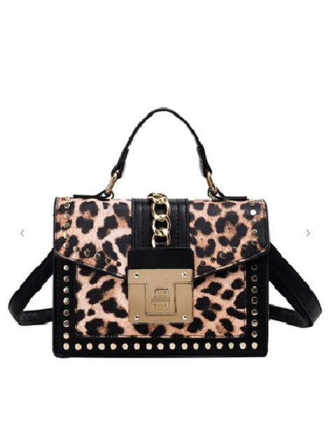 Amp up any outfit and make a statement in this edgy chic leopard print crossbody bag! This purse features a structured silhouette with gold colored studs and chain hardware for an added edge and a detachable crossbody strap. With separated compartments inside, this bag is perfect for the on the go gal. Measurements: Approx. 8" x 6" x 4". Your style will be roaring with confidence with this must-have accessory! The animal print handbag is perfect for concerts, a road trip or a night out on the to Animal Print Handbags, Leopard Print Bag, Velvet Flares, Edgy Chic, Art Necklaces, Printed Purse, Leopard Animal, Bell Bottom Pants, Crossbody Strap