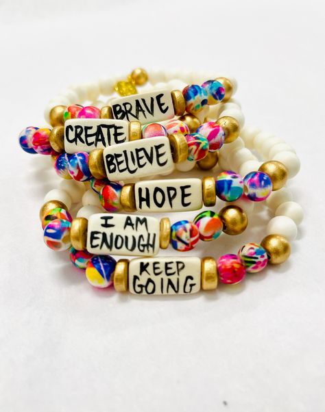 Affirmation bracelets featuring a hand-lettered affirmation focal bead and abstract print beads Stretchy to fit most wrists. Bead size - 8mm Focal bead - 18mm 7.75" centerline Beaded Bracelet Thick, Bracelets With Sayings, Inspirational Word Bracelets, Friendship Bracelets Designs With Beads, Bracelet Sets Diy, Jewelry Making With Beads, Beaded Crafts To Sell, Encouraging Bracelets, Bohemian Bracelets Diy