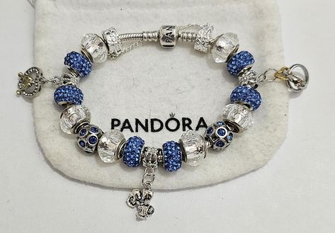 AUTHENTIC Pandora Barrel Clasp Bracelet  These are purchased from Pandorac and come with a receipt. While I use high quality beads and charms on the Pandora bracelet,  the charms and beads used on the bracelet are NOT Pandora Brand, making the bracelet very affordable.  #1  Beads and charms include: Blue single core diamond faceted beads, Knight charm, Carriage bead, "Once upon a time" charm, Castle Bead, Dragon charm #2  Beads and charms include: Crystal single core diamond faceted beads, blue crystal beads, Crystal Heart with Glasses charm, Kissing Couple charm, Wedding Rings charm Includes  Security Chain, Clasp Bead, Gift box and ships USPS Priority Mail Pandora Bracelet Shown is  7.9 with barrel clasp Per Pandora  Make your jewelry the last thing you put on in the morning and first th