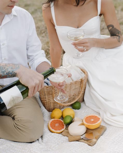 Picnic date at your engagement session? I’ll be there! 🍊🥂🍋 Engagement Photos Champagne Picnic, Engagement Picnic Photoshoot, Cheers Engagement Photos, Couple Poses Picnic, Engagement Picnic Photos, Beach Picnic Photoshoot Couple, Picnic Engagement Photoshoot, Engagement Photo Picnic, Picnic Couples Photoshoot