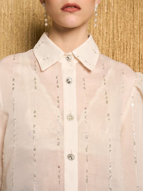 Elevate your wardrobe with our Lyrical Bead Oversized Shirt. Crafted from a bead-embellished organza fabric, this oversized shirt is a symphony of style and sophistication. Fastened with gem buttons, it adds a touch of elegance to your everyday essential shirt, infusing a classic garment with a modern twist. A notable companion to the Gloria Tweed Trousers. Shirt Embellishments, Essential Shirt, Beaded Shirt, Tweed Trousers, Organza Shirt, Embellished Shirt, Organza Fabric, Dancing Queen, Chiffon Shirt