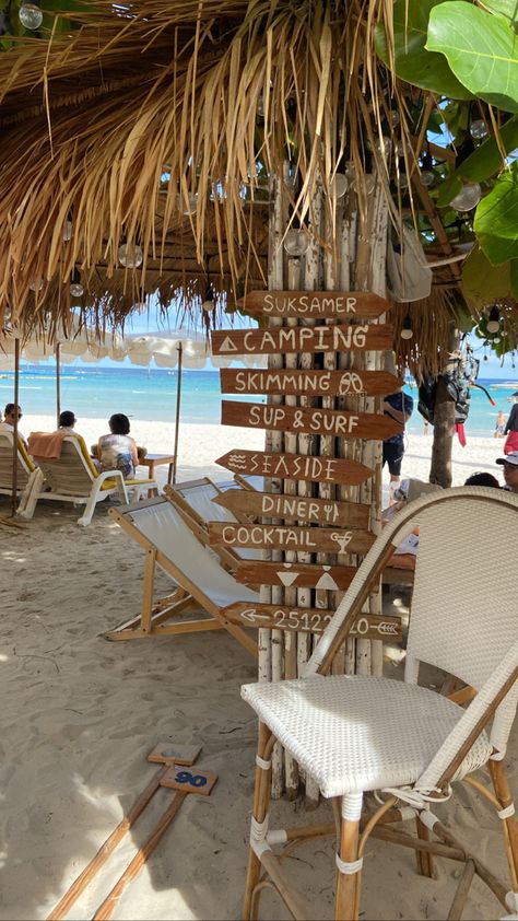 Beach signs with beach chair in neutral colors in a beach with clear blue waters in the background Pattaya Beach Aesthetic, Travel Aesthetic Thailand, Pattaya Thailand Aesthetic, Thailand Beach Aesthetic, Beach Hotel Aesthetic, Thailand Scrapbook, Thailand Resort, Travelling Couple, Thailand Aesthetic