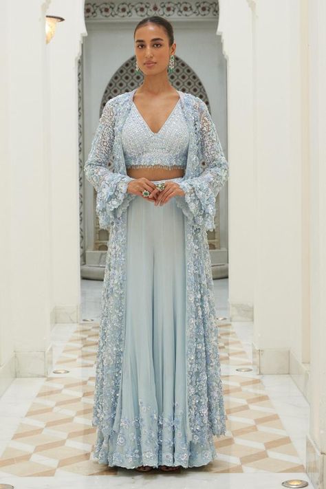 Ice blue longline jacket embroidered in tonal and silver beads, sequins and crystals and bell sleeves. Paired with a padded embroidered bustier and sharara. Components: 3 Pattern: Embroidered Type Of Work: Sequin, Bead, Crystal Neckline: V Neck Sleeve Type: Bell Fabric: Net, Georgette Color: Blue Occasion: Wedding, Mehendi and Haldi - Aza Fashions Blouse And Sharara, Jacket Sharara, Net Jacket, Sky Blue Outfit, Blue Sharara, Embroidered Bustier, Wedding Mehendi, Turquoise Clothes, Georgette Sharara
