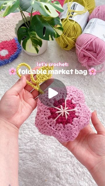 ✿ sol ✿ on Instagram: "The weather is warmer and the cherry blossoms are in full bloom! 🌸 As someone who constantly forgets her reusable bags at home, I wanted to make this adorable foldable market bag to take on my errands with me! ✨💕 (my favourite part is the little leaf 🌱) #MichaelsMakers 

materials used: Loops & Threads Impeccable yarn from @michaelsstores

Be sure to follow @Michaelsstores for more crochet inspo and share how you #MakeitwithMichaels ♡ 

__________🤍__________ 
#crochetersofinstagram #crochetlove #crochetinspo #trendingreels #crochetreels #sundropsol #cherryblossoms #springprojects #everythingtocreateanything" Crochet Reusable Bag, Folding Crochet Bag, Crochet Collapsible Bag, Foldable Bag Crochet, Crochet Market Bag Foldable, Foldable Market Bag Crochet Pattern, Crochet Foldable Market Bag, Foldable Market Bag, Market Bag Crochet