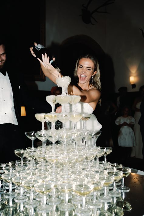 Bride is stood over a tower of champagne glasses and pouring champagne into the glasses: whilst smiling and enjoying her wedding day. Champagne Tower Wedding, Dream Wedding Decorations, Nye Wedding, Champagne Tower, Wedding Money, Dream Wedding Ideas Dresses, Future Wedding Plans, Classy Wedding, Champagne Wedding