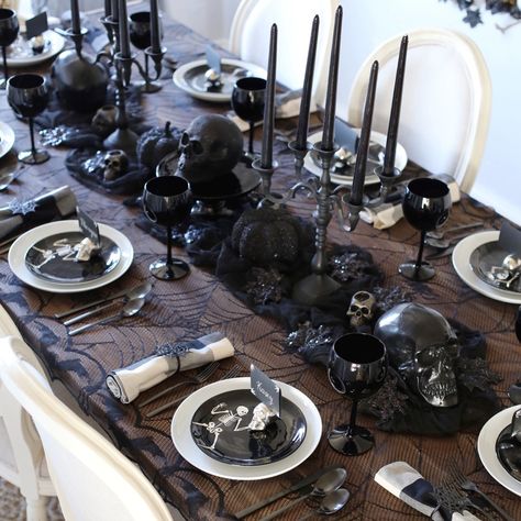 halloween decorations dinner party table setting tablescape Spooky Halloween Table Decor, Halloween Decor Townhouse, Skeleton Table Decor, How To Decorate A Witches Cauldron, Gothic Table Decorations, Salem Witch Party Ideas, Black Skeleton Decor, Skeleton Dinner Party, Halloween Table Scape Ideas