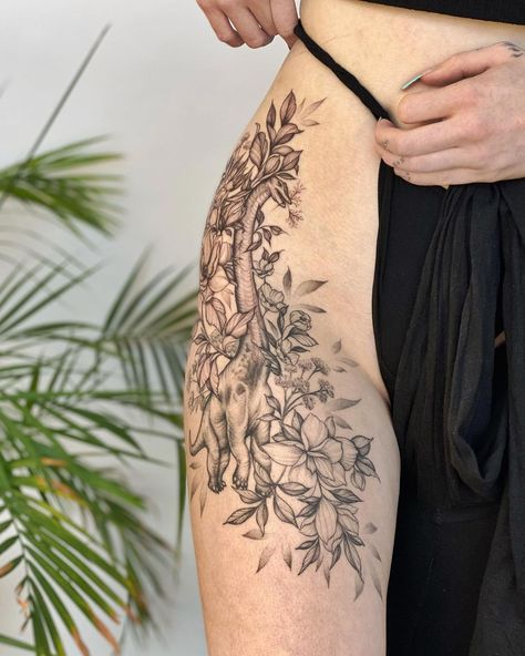 Thigh Dinosaur Tattoo, Dinosaur Tattoo Thigh, Dinosaur Tattoos Realistic, Dinosaur Sleeve Tattoos For Women, Dinosaur Skeleton Tattoo Floral, Dinosaur Back Tattoo, Dinosaur Space Tattoo, Dinosaur Knee Tattoo, Dinosaur Floral Tattoo