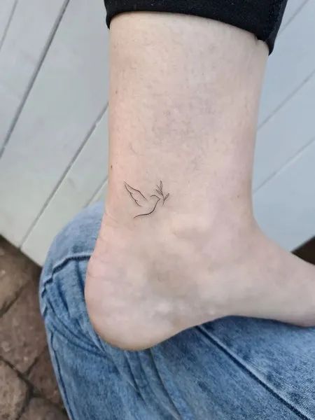 Small Dove Tattoo Dove Tattoo On Ankle, Dove Tattoo With Initials, Friendship Dove Tattoo, Dove Stick And Poke, Dove Tattoo Meaning For Women, Dove And Olive Branch Tattoo Simple, Dove Tattoo On Hip, White Ink Dove Tattoo, Tiny Dove Tattoos For Women