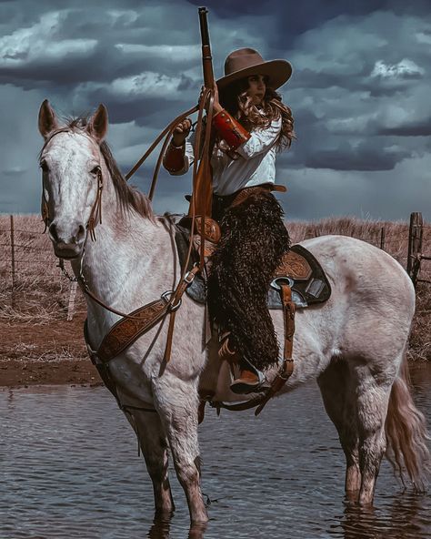 Outlaw woman on horse in Wilkie chaps in the water holding a rifle Outlaw Aesthetic Women, Outlaw Outfit, Outlaw Aesthetic, Female Cowboy, Western Drawings, Cowgirl Era, Cowgirl Photography, Outlaw Women, Gamora Marvel