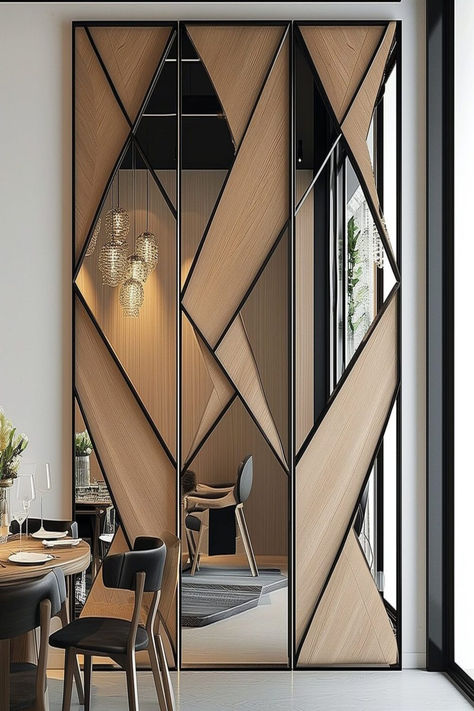 A modern dining room with a large geometric mirror wall design divided by wooden strips, reflecting a chic interior. Mirror Wall Design, Wall Partition Design, Mirror Interior Design, تصميم داخلي فاخر, Wall Panel Design, التصميم الخارجي للمنزل, Living Room Partition Design, Room Partition Designs, Mirror Design Wall