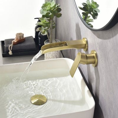 Influenced by modern home decor trends, wall-mounted faucets fit perfectly into the minimalist style. It not only saves space, but also brings a touch of modern elegance to the bathroom. The waterfall spout design on the upper opening allows you to clearly see every drop of water flowing out. Feel the collision with nature. All in all, just a great recommended product to decorate your bathroom. Finish: Gold | Tomfaucet Wall Mounted Bathroom Faucet in Yellow | 9.2 H x 6.3 W x 2.76 D in | Wayfair Wall Faucet Bathroom, Brass Sink Faucet, Wall Mounted Bathroom Faucet, Spout Design, Wall Faucet, Drop Of Water, Water Flowing, Wall Mount Faucet Bathroom, Single Handle Bathroom Faucet