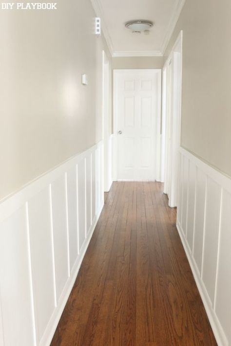 White hallway board and batten for less than $100. Such an easy DIY project that adds so much to any boring wall. Board And Batten Hallway With Pictures, Wainscoting With Wallpaper Hallway, Open Floor Plan Board And Batten, Hallway Beadboard Ideas, Narrow Hallway Board And Batten, Beadboard Hallway Ideas, Beadboard Half Wall Hallway, Batten Wall Hallway, Hallway Trim Ideas