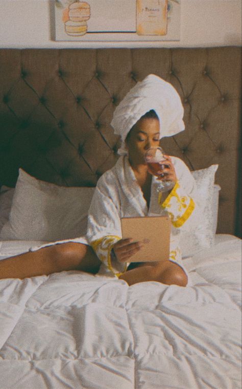 Black woman sitting on comfy bed wearing a thick white robe sipping wine while reading on a tablet her hair is wrapped in a terry white towel on top of her head. Black Woman Luxury, Luxury Self Care, Embracing Femininity, Black Femininity Aesthetic, Femininity Aesthetic, Vision Board Pics, Vision Board Printables, Luxury Lifestyle Aesthetic, Vision Board Party