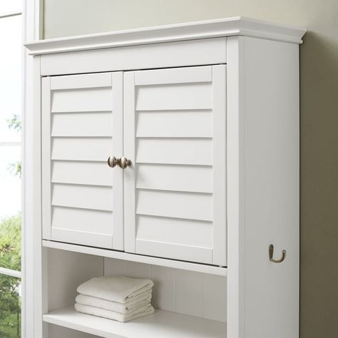 Designed specifically to fit in the rarely used space above the toilet, the Lydia Over the Toilet Storage Cabinet keeps your bathroom organized. Keep toiletries and grooming items out of sight in the large storage cabinet with an adjustable shelf. Below the cabinet is a spacious open shelf ideal for keeping items like hand towels and washcloths close at hand. Handy utility hooks on each side are perfect for hanging a bath towel or robe. Sitting flush against the wall, this bathroom cabinet is everything you need for small space organization.