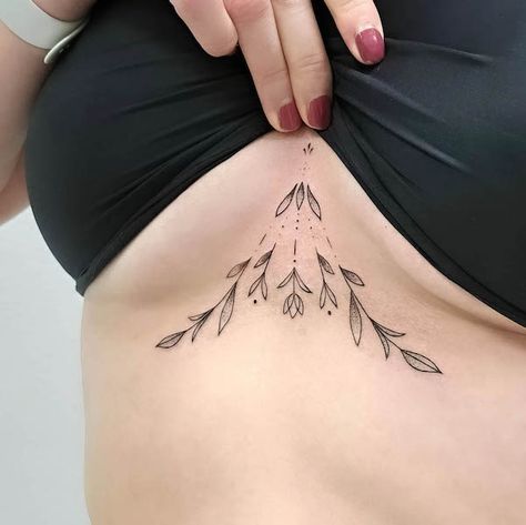 63 Attractive Underboob Tattoos With Meaning - Our Mindful Life Under Bobs Tattoos Small, Women’s Underboob Tattoo, Sternum Tattoos For Women Small, Underbreast Tattoos For Women, Underbust Tattoo Ideas Floral, Floral Tattoo Sternum, Sternum Fine Line Tattoo, Sternum Leaf Tattoo, Fine Line Tattoo Under Breast