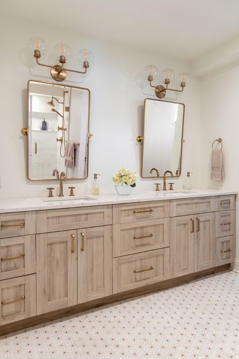 Transform your bathroom into a functional and stylish space. Our custom cabinetry will optimize every inch, making the most out of your small space.  This bathroom was designed by Paula Anane at Perspective Cabinetry & Design using Showplace cabinetry.  Contact us today to schedule your remodel in St. Louis, MO. #customcabinetry #bathroomremodel #perspectivecabinetry #showplacecabinetry Gold Hardware Vanity, Wood And Gold Bathroom Vanity, White Oak Master Bath Vanity, Bathroom Vanity His And Hers, Master Bathrooms With Double Vanity, Double Vanity Guest Bathroom, Cream And Brass Bathroom, Bathroom With Separate Vanities, Wall To Wall Bathroom Vanity