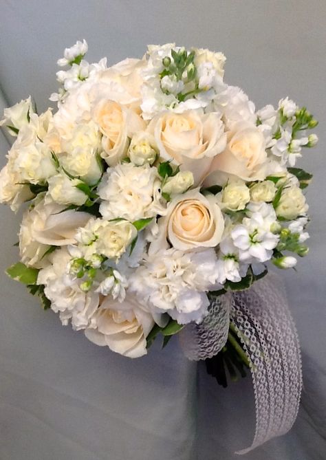 This bridal bouquet was done in white Stock, Ivory Spray Roses, white Carnations, and Vendela roses, wrapped with burlap and lace. White Roses And Carnations Bouquet, White Carnation Bouquet, Sienna Wedding, Carnations Bouquet, Wedding Bouquets White, Daisy Bridal Bouquet, Vendela Roses, Man Bouquet, White Carnations