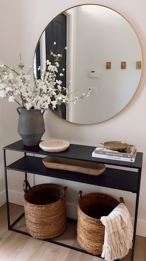 Welcome guests in style with these key elements for a stunning entryway! Explore our chic list and make your home's entrance unforgettable. Click to find out more! #ChicEntryway #HomeStyling #InteriorDesign Entrance Console Design, Black Console Table Entryway, House Entrance Ideas Entryway, Black Entryway Table, Chic Entryway, Entrance Ideas Entryway, Entrance Table Decor, Round Brass Mirror, Entrance Console Table
