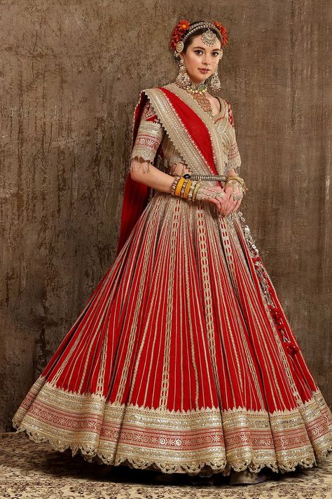 Red shimmer chanderi lehenga with gota, dori and badla work 9 inch border. Comes with blouse and net dupatta. Component: 3 Pattern: Embroidery Type Of Work: Goti, Dori, Badla and Zari Neckline: Leaf Sleeve Type: Half Fabric: Lehenga: Cotton Shimmer Chanderi, Blouse: Silk Chanderi and Dupatta: Net; Lining: Shantoon and Taffeta Silk          Color: Red Other Details:  Dupatta with embroidered border and beaded tassels Blouse with cutwork hem and bead tassels Low back with tie up as tassels Scallop Chanderi Lehenga, Lehenga And Blouse, Lehenga Pattern, Set Saree, Lehnga Designs, Blouse Silk, A Line Kurta, Red Lehenga, Embroidered Lehenga