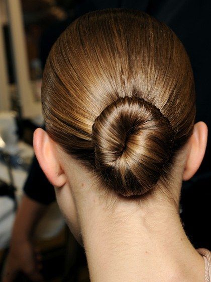 To get this look, as seen at the Givenchy spring 2013 show, part your hair straight down the middle and pull it into a low, tight ponytail. Twist the tail around into a tight bun and pin it neatly in place. Mist on a light-reflective spray, like Bumble and Bumble Shine On (And On...) Finishing Spray, to control flyaways and give hair a glassy sheen. Fashion Week Hairstyles, Week Hairstyles, Catwalk Hair, Fashion Week Hair, Underlights Hair, Fly Away Hair, Ballerina Bun, Gorgeous Braids, Sleek Updo