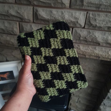 This crochet book sleeve is perfect for protecting your A5-sized books. Made with acrylic yarn, it provides a soft and cushioned cover for your favorite books. The green and black checkered design adds a stylish touch to your reading experience. Keep your books safe and stylish with this unique book sleeve! - Dimensions: A5 size - Material: Acrylic yarn Please note that each book sleeve is handmade, so slight variations in color and pattern may occur. Order yours today and add a touch of crochet charm to your reading collection! Crochet Book Sleeve, Crochet Book, Checker Design, Book Safe, Checkered Design, Black Checkered, Book Sleeve, Unique Book, Crochet Books