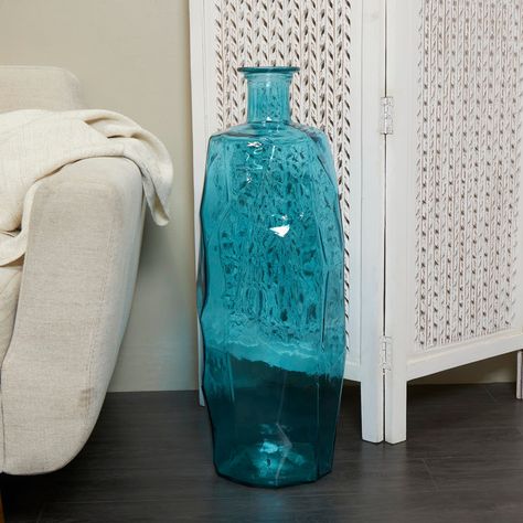 "Find the 29\" Teal Recycled Glass Tall Spanish Bottleneck Vase at Michaels. com. This coastal glass vase features a cylinder bottle shape and a transparent glass exterior. Accessorize your space effortlessly by displaying a beautiful floral arrangement or greenery with this decorative vase. Create a balanced surface space and added dimension with this beautifully crafted vase. Inspired by sleek elegance and clean lines, a minimalistic design offers effortless luxury with monochromatic tones and Tall Glass Vase Filler Ideas, Tall Clear Vase Filler Ideas, Clear Vase Filler Ideas, Glass Vase Filler Ideas, Tall Clear Vase, Vase Filler Ideas, Teal Vase, Tall Glass Vase, Rope Decor