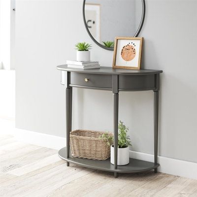 Give your living room or entryway a glow-up with a beautiful new Half-Moon Console Table. The classic elegance of the half-moon top and tapered legs create a vintage yet sophisticated feel perfect for any décor. This half-moon Console Table features a spacious drawer to keep clutter out of sight and a lower shelf for books, photos, or other decorative items to cozy up the room. Made sturdy painted MDF, the Console Table is as durable as it is affordable and assembly is a snap! With the preassemb Small Entry Tables, End Of Hallway, Shelf For Books, Small Entryway Table, Half Moon Console Table, Half Moon Table, Small Console Table, Console Table Decorating, Narrow Console Table