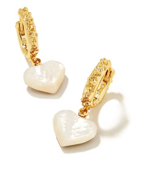 PRICES MAY VARY. Show some love to your earring stack with the Kendra Scott Penny Heart Huggie Earrings with mother of pearl. Petite heart shapes dangle from textured huggies for a style that's as sweet as it is chic. These huggies will add a touch of romance to ever Goldtone finish. Hinge with notched post back finding. Pearl Earring Stack, Gracie Gold, Gold And Silver Earrings, Summer Room, Short Pendant Necklace, Earring Stack, Pandora Earrings, Coastal Jewelry, Huggie Earrings Gold