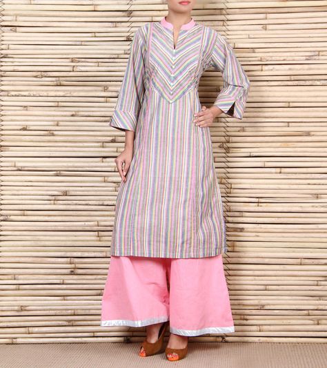 This is a cotton striped kurta with diagnol stripes on the yoke and sleeves eith a pink collar and piping on the frnt with silver buttons. It is paired with pink cotton palazzos with a silver patti on the bottom. Dirndl, Stripes Kurta Women, Vertical Stripes Kurti Designs Latest, Striped Kurta Designs Women, Strip Kurti Designs Latest, Stripes Kurti Designs Latest, Stripes Kurti Designs, Striped Kurta, Kurti Patterns