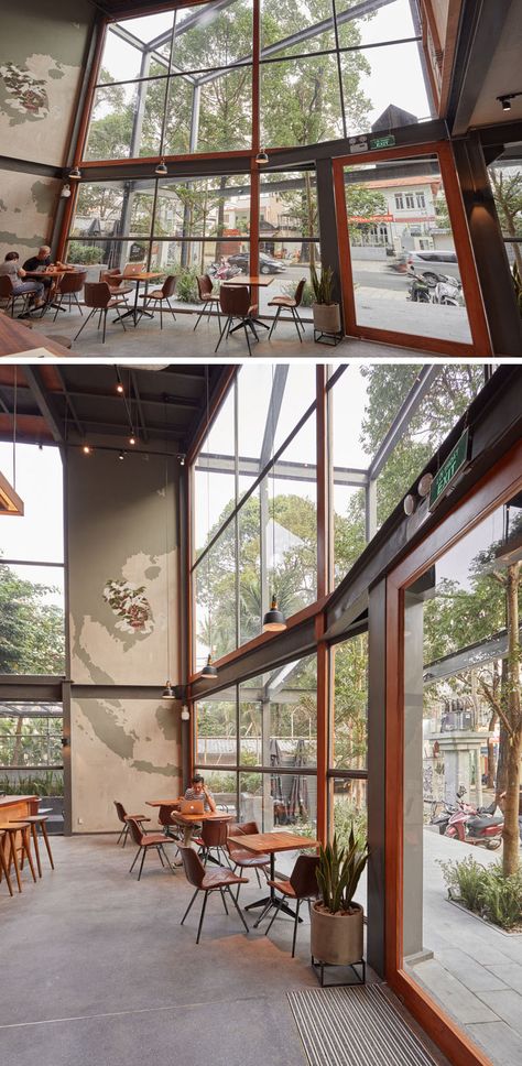 A large wall of windows floods the interior of this modern coffee shop with natural light and seating positioned next to the windows provides customers with street views. #CoffeeShop #Windows #Architecture The Coffee House Vietnam, Window Coffee Shop, Seating Window, Windows Architecture, Coffee House Design, Modern Coffee Shop, Cafe Window, Cafe Seating, Coffee Shop Interior Design