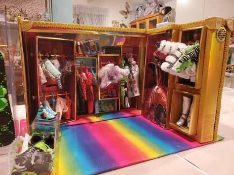 Big Rainbow High Doll wardrobe/closet made from the doll boxes. Using wooden sticks painted gold for closet poles. Boxes are cut up and strengthened with firm card stock and glue gunned onto a foam a core base. A fun do it yourself project. Doll Display Rainbow High, Rainbow High Doll Collection Display, Rainbow High Doll Collection, How To Make Rainbow High Doll Clothes, Rainbow High Display, Rainbow High Doll Display, Diy Rainbow High Doll Clothes, Rainbow High House, Rainbow High Custom Doll