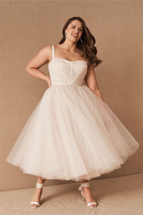 This vintage wedding dress with a tulle skirt is one of our WeddingWire editors' top picks. WeddingWire has tons of recommendations for wedding dresses and jumpsuits for all wedding types. Click for more courthouse wedding dress ideas. Planning your wedding has never been so easy (or fun!)! WeddingWire has tons of wedding ideas, advice, wedding themes, inspiration, wedding photos and more. {BHLDN} Floral Wedding Dress Simple, Short White Dress Plus Size, Tea Length Wedding Dress Plus Size, Plus Size Tea Length Wedding Dress, City Hall Wedding Dress, Plus Size Midi Dress, Courthouse Wedding Dress, Midi Wedding Dress, Plus Wedding Dresses