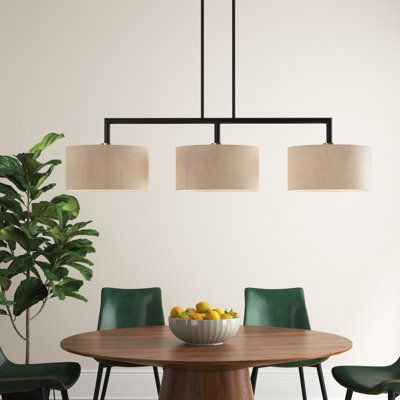 This 3-light linear pendant features a clean, crisp look that brings a modern feel to your kitchen island or a long dining room table. The sleek upper frame is crafted from steel with a metallic finish. Each of the three oatmeal-hued fabric drum shades tempers the light from a 60W max bulb (sold separately). This fixture hangs from two height-adjustable rods and a circular canopy. It's also compatible with dimmer switches, so you're able to get just the right ambiance wherever this is installed. Light Above Kitchen Table Modern, Dinning Room Table Pendant Lights & Chandeliers, Cozy Dining Room Lighting, Conference Room Chandelier, Pendant Lights Over Bar Counter, Organic Modern Dining Room Chandelier, Midcentury Modern Dining Room Light, Modern Organic Kitchen Lighting, Timeless Dining Room Lighting