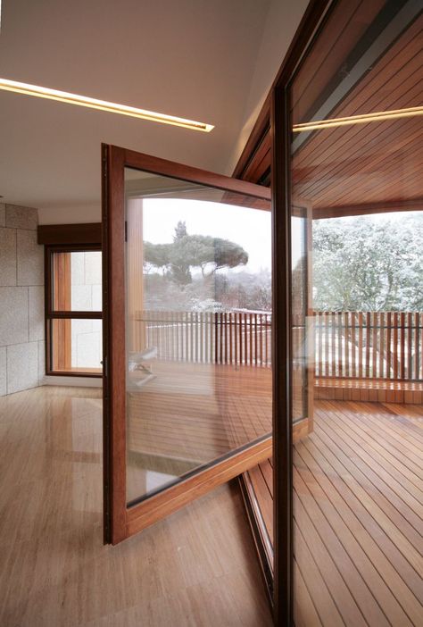 Large wood framed windows rotates open onto wooden front balcony. Studio Dwelling / cmA Arquitectos. Fasad Design, Pivot Door, Window Door, Design Del Prodotto, Decoration Inspiration, Madrid Spain, The Doors, 인테리어 디자인, Future House