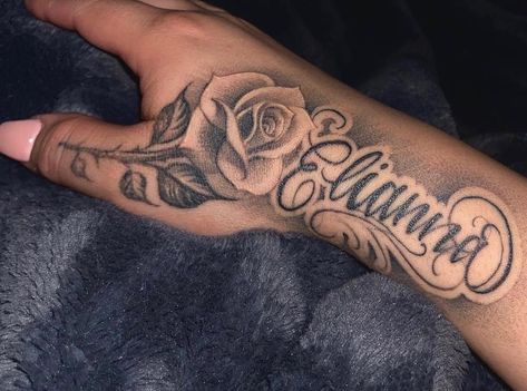 Cursive Last Name Tattoos, Flower Hand Tattoo With Name, Hand Name Tattoos Men, Forearm Name Tattoo Women, Arm Tattoos For Lost Loved Ones, Arm Name Tattoos Men, Name Hand Tattoos Men, Name Tats Tattoo Ideas, Tattoo Name On Wrist