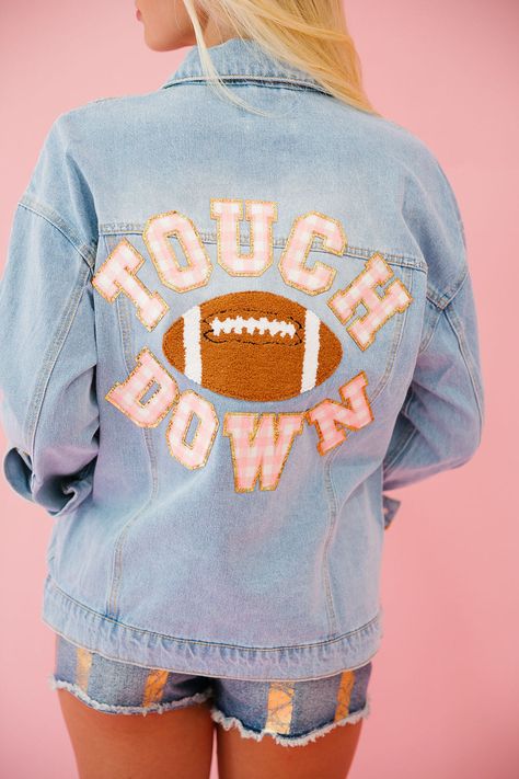 Score a fashion touchdown with our TOUCHDOWN SEASON DENIM JACKET! This denim jacket features mini glam pink striped Touchdown letters and a football patch for a playful and unique look. Stay stylish and cozy all season long! All orders are currently shipping within 14 business days. To receive item quicker, expedited shipping is available at checkout.