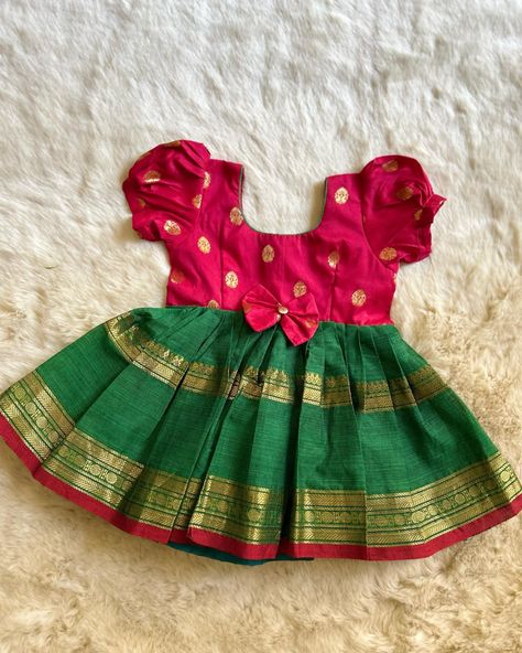 Simple yet traditional! The timeless trend! Red with Bottle Green (Bow)- Kanchi Cotton South Indian Ethnic Frock for Baby Girl Instock: 0-3 Years www.babynmeindia.com 🔎REDGREBOWKCFRO Baby Traditional Dress Indian, Simple Frocks For Kids, Baby Girl Dresses Indian, Frock For Baby Girl, Traditional Baby Dresses, Baby Lehenga, Cotton Frocks For Kids, Frocks For Babies, Ikat Blouse