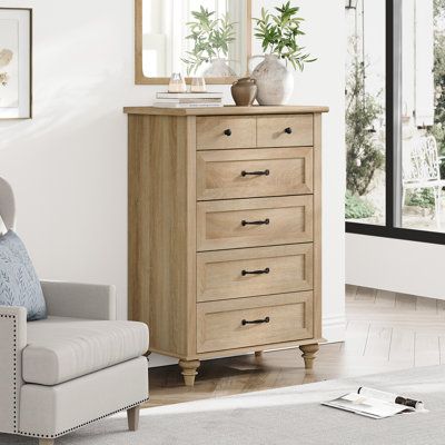 This 5-drawer dresser complements any French country space while offering lots of extra storage space. Its frame is made from engineered wood with a rustic white and brown finish, and it rests on turned legs for a classic silhouette. The five spacious drawers open on metal slides and provide ample room for everything from your clothing and linens to delicates and jewelry. We love how the black-finished metal drawer pulls around out its farmhouse look in your bedroom or guest room. Plus, there's Dresser Chest Of Drawers, Tall Dresser Decor Top Of, Bedroom Tall Dresser Decor, Timeless Bedroom Furniture, Bedroom Ideas Dressers, Tall Dresser Decor Bedroom, Tall Dresser Decor, Tall Dressers, Dressers Bedroom