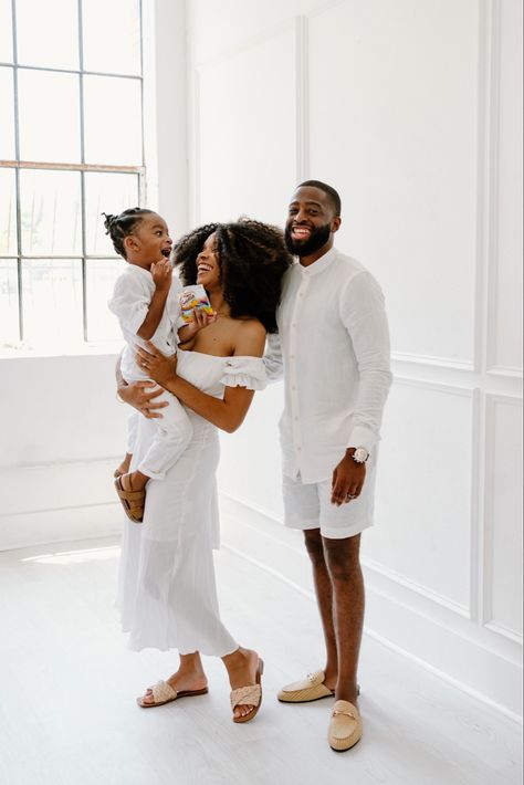 Black family smiling in all white Photoshoot Family Photo White Background, All White Family Photoshoot, White Family Photo Outfits, All White Photoshoot, Easter Family Outfits, Family Easter Outfits, Photoshoot Outfits Spring, Winter Photoshoots, White Photoshoot