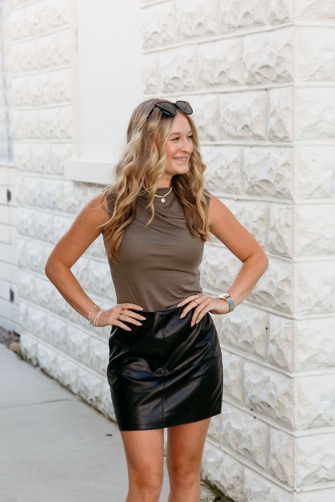 The short black faux leather skirt is a fall and winter wardrobe staple. Timeless and versatile, you will have this piece for many seasons to come! This skirt can be worn with a bodysuit and a pair of loafers for a simple semi-casual look, or style this skirt with black tights, heels, and your favorite "going out top"! short black faux leather skirt high waisted side zipper fitted, model wears size small hand wash cold, hang to dry 50% polyurethane leather, 50% rayon Skirt With Black Tights, Black Faux Leather Skirt, Semi Casual, Romper And Jacket, Cowl Neck Top, Going Out Tops, Faux Leather Skirt, Black Tights, Sophisticated Style