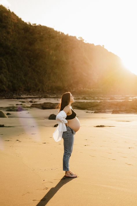 A gorgeous golden hour back lit image from a recent Sunset Maternity session in Raglan New Zealand. - Photographed by Hamilton New Zealand Maternity and Newborn Photographer Catherine Smith Photography Open Jean Maternity Photos, Jeans And Shirt Maternity Shoot, Maternity Photo Jeans And Shirt, Light Blue Maternity Dress Photoshoot, Sunset Maternity Photography Beach, Casual Maternity Pictures Beach, Jeans Beach Maternity Shoot, Boardwalk Maternity Photos, Maternity Photography In Jeans