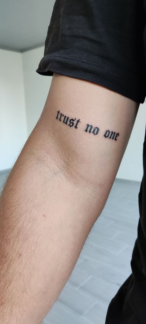 Trust No One Tattoo: Tattoos are a powerful means of self-expression, allowing people to communicate their beliefs, experiences, and philosoph Small Eminem Tattoo Ideas, Trust No One Tatoos, Trust No One Tattoo Neck, Trust No One Neck Tattoo, Tattoo Ideas Men Meaningful, Trust No One Tattoo Ideas For Men, Meaningful First Tattoos, Men First Tattoo Ideas, Simple Guy Tattoos