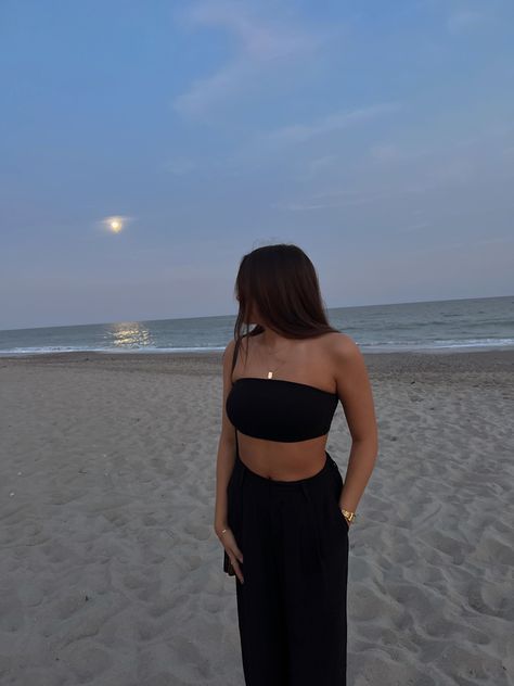 black bandeau top, gold jewelry, black trousers, beach fit, summer, vacation fit Dark Vacation Outfits, Black Pants Beach Outfit, Black Beach Dinner Outfit, Beach Outfit Birthday, Beach Night Life Outfit, Late Night Beach Outfit, Black Beach Pants Outfit, Silk Skirt Outfit Black, Beach Trousers Outfit