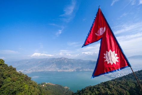 Nepal was unified during the reign of the Gorkha king Prithivi Narayan Shah in the mid-1700s, and many accounts date the creation of the double-pennant, sun-and-moon flag to around this time, or to the early 1800s. | image The Nepali national pennant Nepali Flag Wallpaper, Nepal Flag Image, Flag Nepal, Nepali Flag, Flag Of Nepal, Mandala House, Edits Pictures, Nepal Flag, Olympic Flag