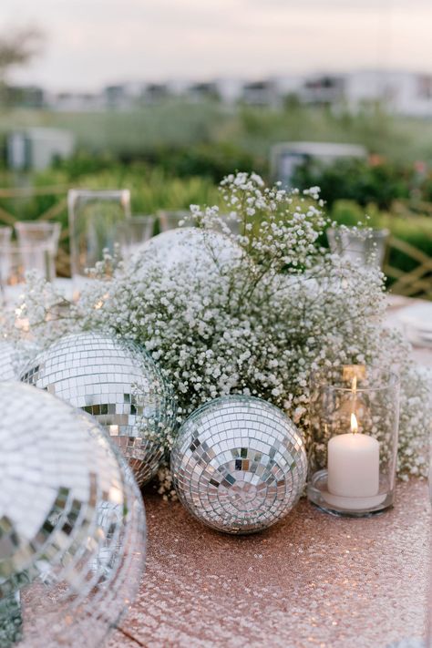 Disco Balls Party Decor, Gypsophila Disco Ball, Nye Wedding Table Decor, Disco Balls Decoration, Disco Ball And Candles, Engagement Party Disco Ball, Disco Engagement Party Ideas, All White New Years Eve Party, Mirrorball Wedding Decor