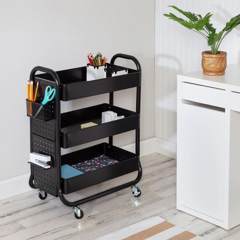 "Purchase the Honey Can Do Black Rolling Craft Cart at Michaels. com. Apart from its 3 tray shelves, durable metal build, and wheels, it uniquely features a reconfigurable pegboard on the side, along with accessories like a shelf, basket, and hook. Whether you’re lucky enough to have an art room or are crafting at the kitchen table, this black craft cart with wheels is a game-changer. The ample storage of this craft organizer will keep all your crafting supplies in one place and make both setup and clan up a cinch. Apart from its 3 tray shelves, durable metal build, and wheels, it uniquely features a reconfigurable pegboard on the side, along with accessories like a shelf, basket, and hook. Shift around the accessories however you please to keep the pegboard functional for your arts and cr Rolling Craft Cart, Office Cart, Black Bar Cart, Pegboard Baskets, Pegboard Shelf, Craft Storage Cart, Steel Pegboard, Shelf Basket, Cart With Wheels