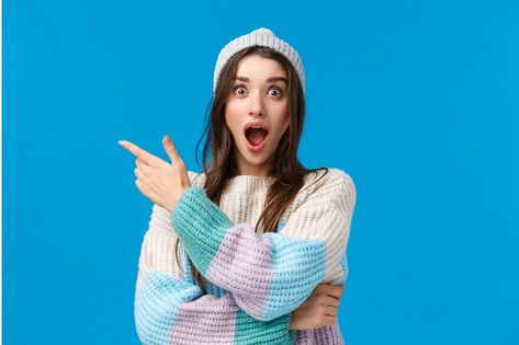 Shocking low prices, check this out. Astonished and speechless, startled excited young woman with long dark hair, winter sweater and hat, open mouth fascinated, pointing finger left, blue background. Woman Looking Down, Excited Girl, Durga Picture, Women Laughing, Headshots Women, Smiling Woman, Instagram Feed Ideas Posts, Caucasian Woman, Women Talk