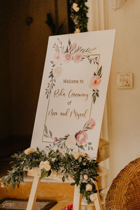 Intimate Home Roka With Stunning Décor Details Wedding Welcome Boards, Roka Decor, Engagement Decorations Indian, Wedding Entrance Decoration, Roka Ceremony, Naming Ceremony Decoration, Engagement Stage Decoration, Nikah Decor, Pastel Outfits